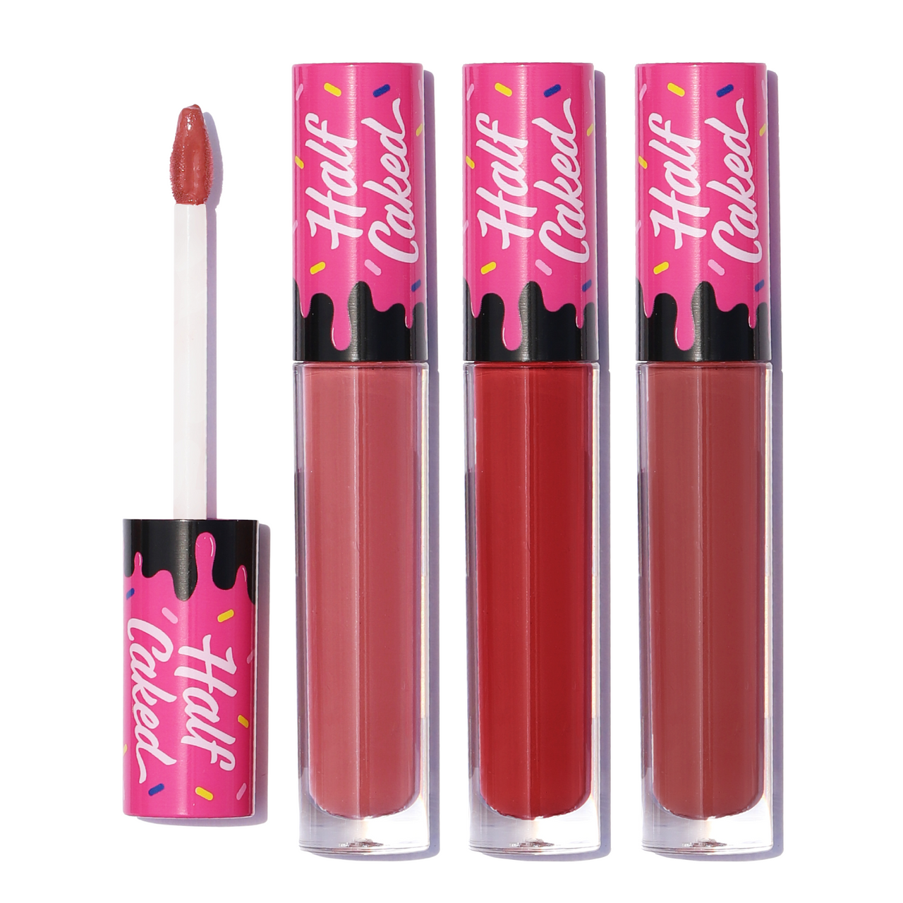 Game Changer Lip Fondant Trio by Half Caked, featuring three vibrant liquid lipsticks in a collector's edition playing card box, with one lipstick applicator open.