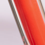 Sheer orange lip gloss in a clear tube with pink cap - Half Caked Instant Crush - 5% Tint