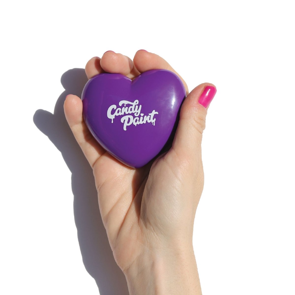 purple heart-shaped compact in hand - candy paint bronzer - half caked