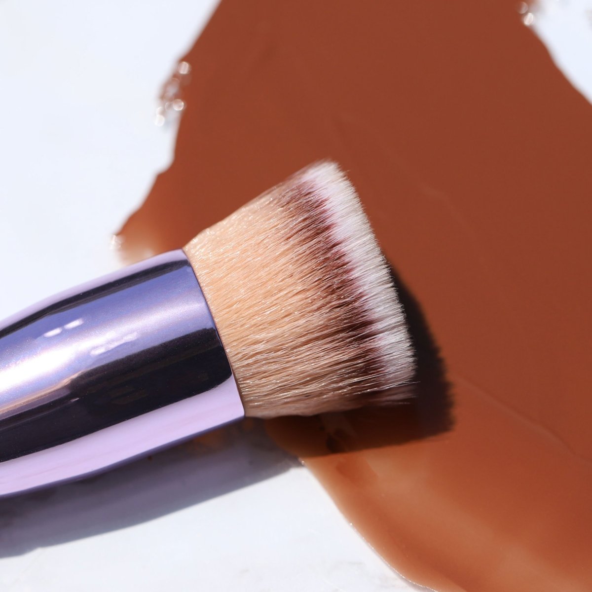 shiny purple flat-top kabuki foundation in brown smear - complexion brush - half caked makeup