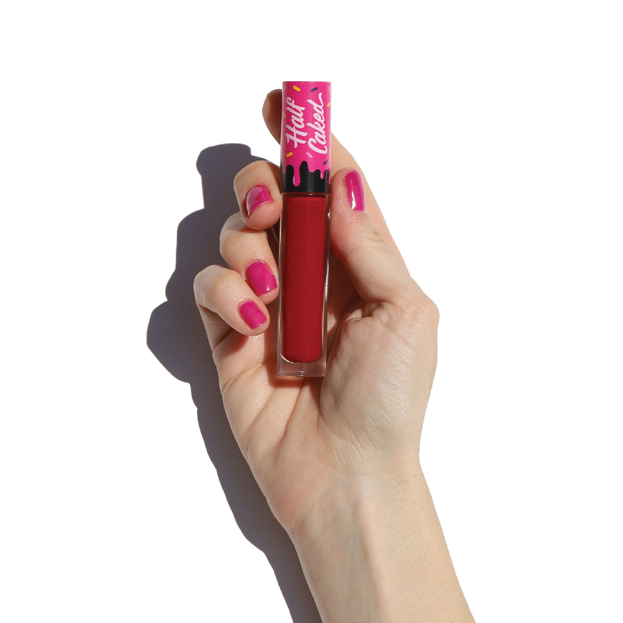 lip fondant liquid lipstick tube in hand with pink nails - game changer - half caked makeup