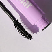 closeup of black plastic curved applicator - totally tubular mascara, the ultimate - half caked makeup
