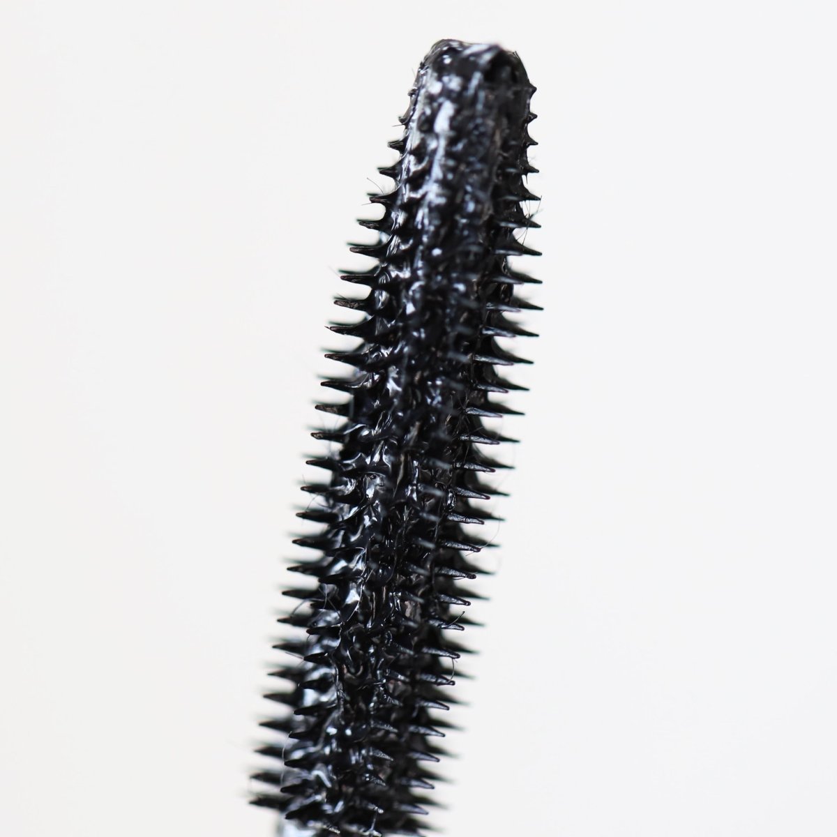 closeup of black plastic cone applicator - totally tubular mascara, the heights - half caked makeup